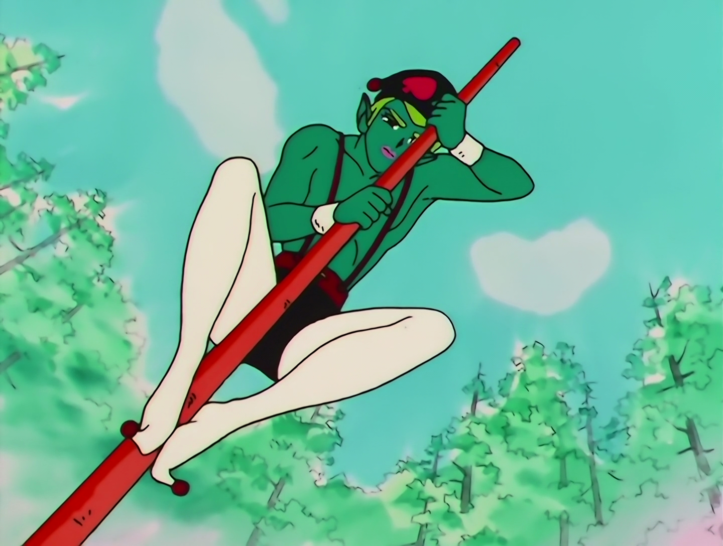 Tsunawatarou, a Lemures from Sailor Moon episode 137. He has dark green skin and light green hair, and his outfit consists of white tights and black shorts held up with… suspenders? I think that’s what you call them in America? Braces, if you’re British. He also has a weird little hat. He’s clinging to a vertical red pole that’s standing on its end.